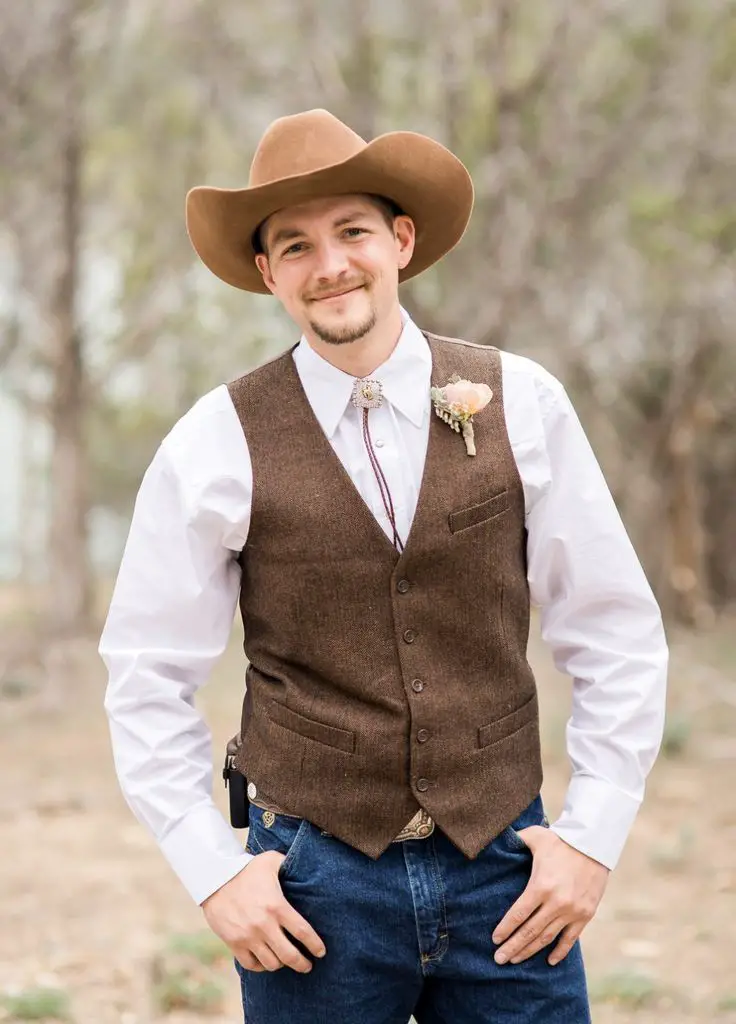 Rustic grooms wedding attire. Groom with cowboy hat.
