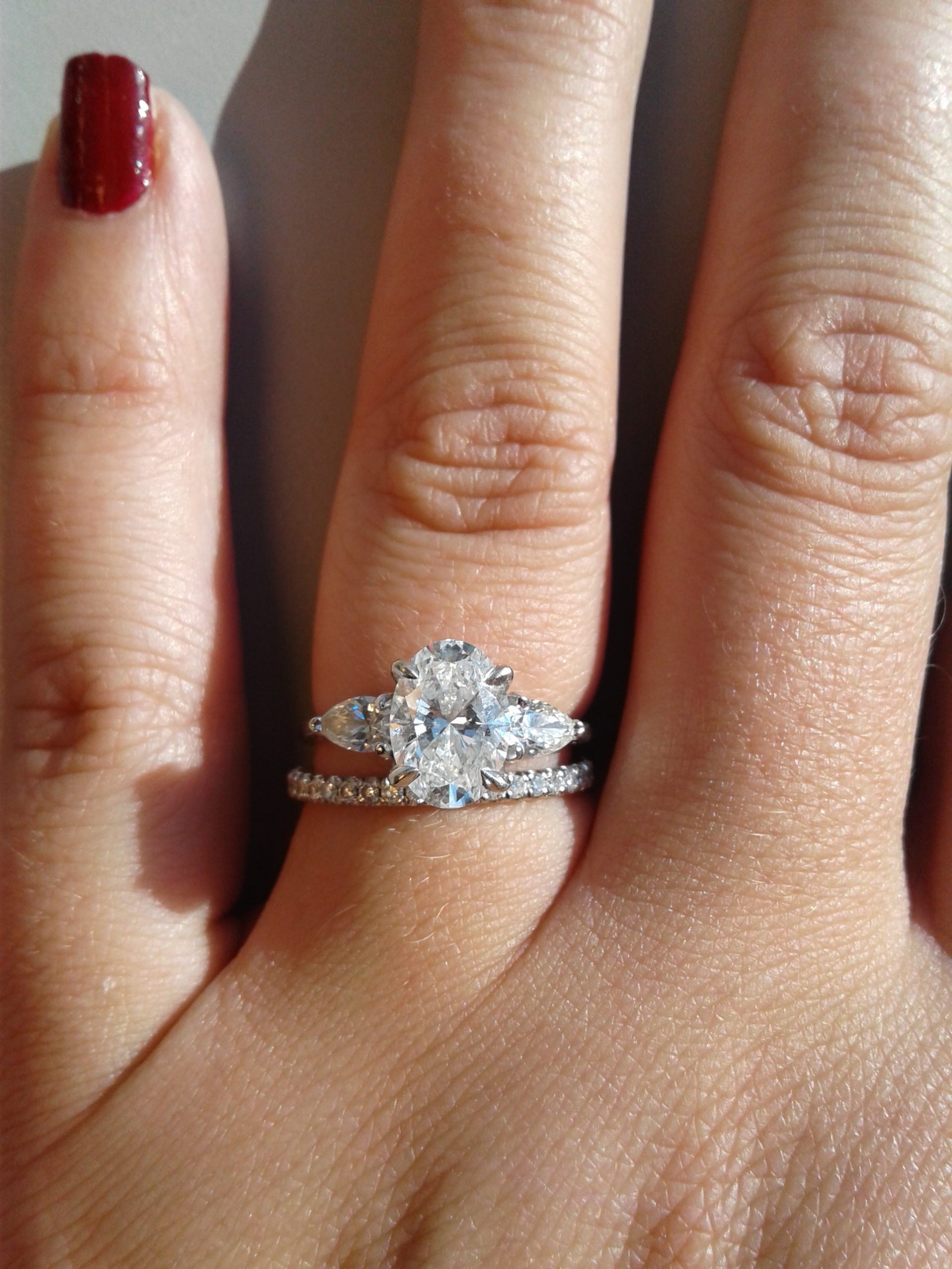 Show me your wedding band with an oval engagement ring